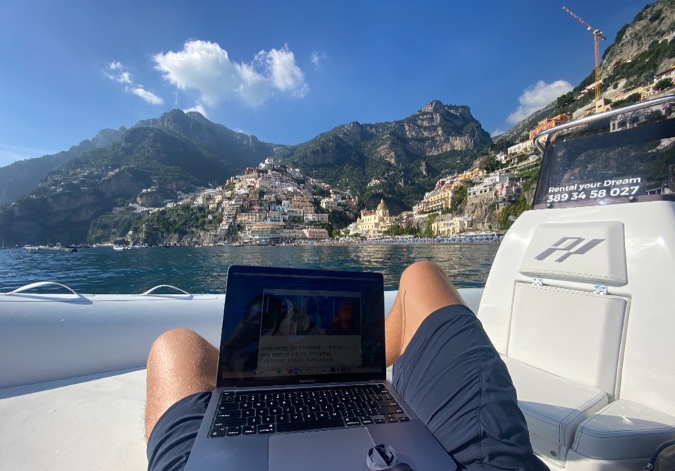 Tom working on a laptop from a boat on the Amalfi Coast