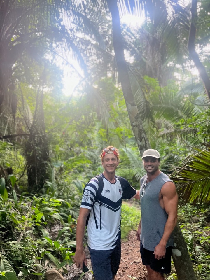 Tom hiking through tropical jungle