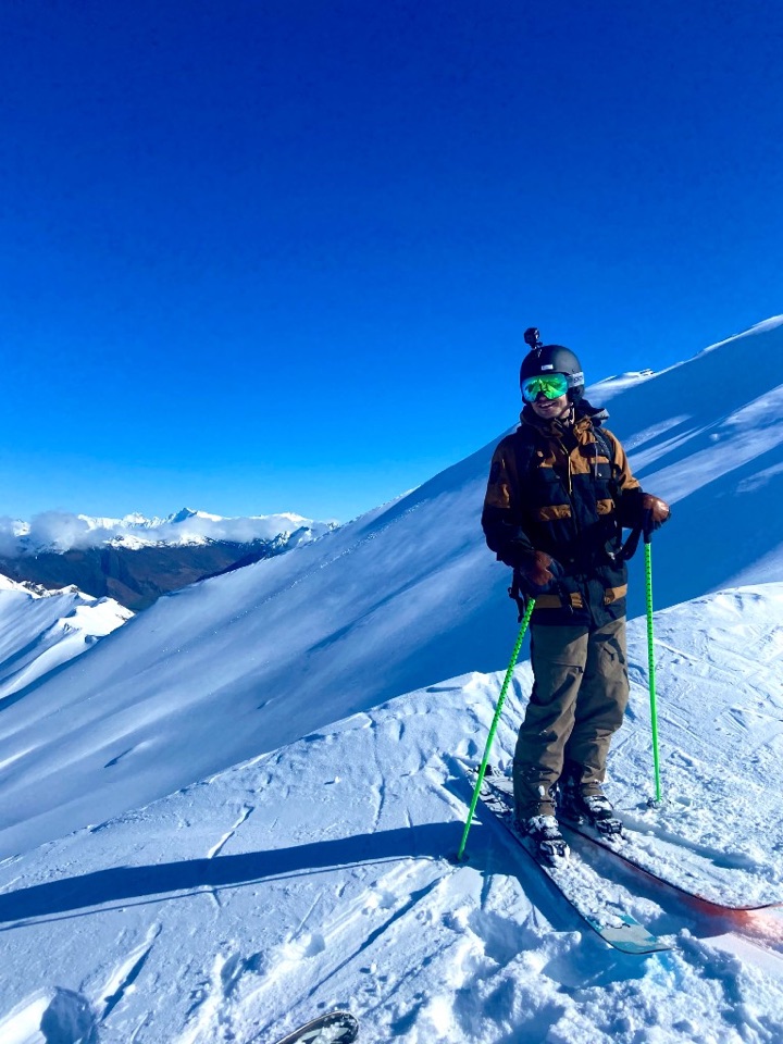 Tom skiing on a mountain ridge